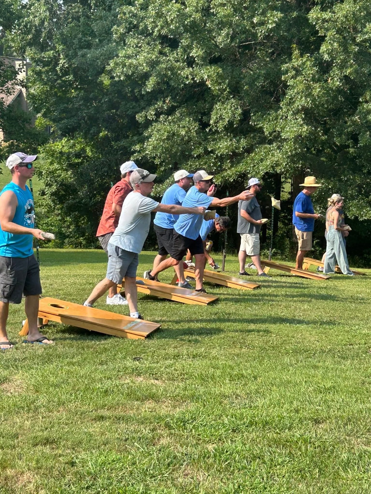 Guests playing a bags tournament match on the lawn
